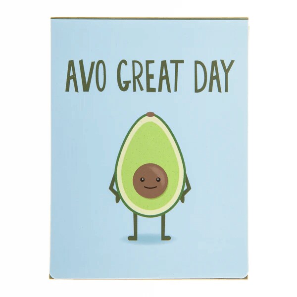 Notebook with a cute cartoon avocado and the pun text 'Avo Great Day' on a light blue cover